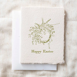 Greeting card with 'Happy Easter' text and floral design on a textured fabric background